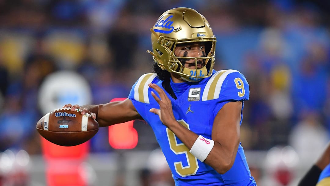 Nov 8, 2025; Pasadena, California, USA; UCLA Bruins quarterback Nico Iamaleava (9) throws against the Nebraska Cornhuskers during the first half at the Rose Bowl. Mandatory Credit: Gary A. Vasquez-Imagn Images
