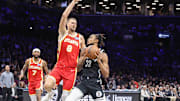 Oct 29, 2025; Brooklyn, New York, USA; Brooklyn Nets center Nic Claxton (33) looks to drive past Atlanta Hawks center Kristaps Porzingis (8) in the second quarter at Barclays Center. Mandatory Credit: Wendell Cruz-Imagn Images