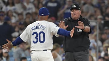 Aug 7, 2024; Los Angeles, California, USA;  Los Angeles Dodgers manager Dave Roberts (30) is ejected by umpire Hunter Wendelstedt (21) after arguing an interference call by Los Angeles Dodgers shortstop Miguel Rojas (11) in the sixth inning against the Philadelphia Phillies at Dodger Stadium. Mandatory Credit: Jayne Kamin-Oncea-USA TODAY Sports