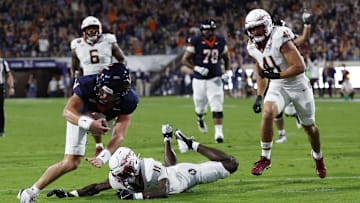 Sep 26, 2025; Charlottesville, Virginia, USA; Virginia Cavaliers quarterback Chandler Morris (4) scores a touchdown s Florida State Seminoles defensive back Ja'Bril Rawls (11) defends during the second quarter at Scott Stadium. Mandatory Credit: Geoff Burke-Imagn Images