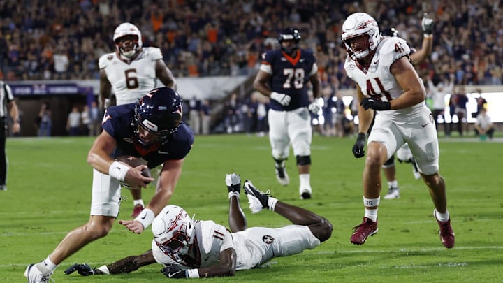 Sep 26, 2025; Charlottesville, Virginia, USA; Virginia Cavaliers quarterback Chandler Morris (4) scores a touchdown s Florida State Seminoles defensive back Ja'Bril Rawls (11) defends during the second quarter at Scott Stadium. Mandatory Credit: Geoff Burke-Imagn Images