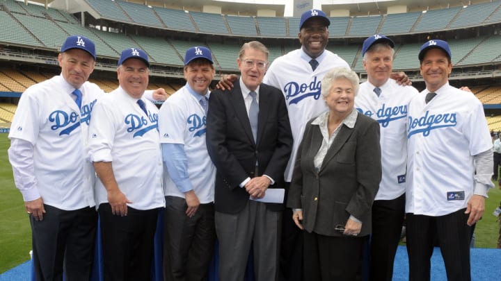 May 2, 2012; Los Angeles, CA, USA; Los Angeles Dodgers former owner Peter O'Malley and former Los Angeles City Councilmember Roz Wyman pose with members of the Guggenheim baseball management team at a press conference to announce their purchase of the Los Angeles Dodgers at Dodger Stadium. From left: Stan Kasten and Bobby Patton and Todd Boehly and O'Malley and Magic Johnson and Wyman and Mark Walker and Peter Guber. Mandatory Credit: Kirby Lee/Image of Sport-USA TODAY Sports