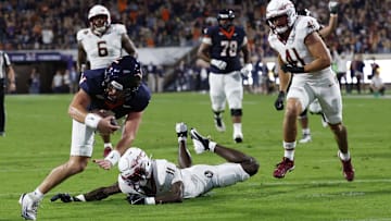 Sep 26, 2025; Charlottesville, Virginia, USA; Virginia Cavaliers quarterback Chandler Morris (4) scores a touchdown s Florida State Seminoles defensive back Ja'Bril Rawls (11) defends during the second quarter at Scott Stadium. Mandatory Credit: Geoff Burke-Imagn Images