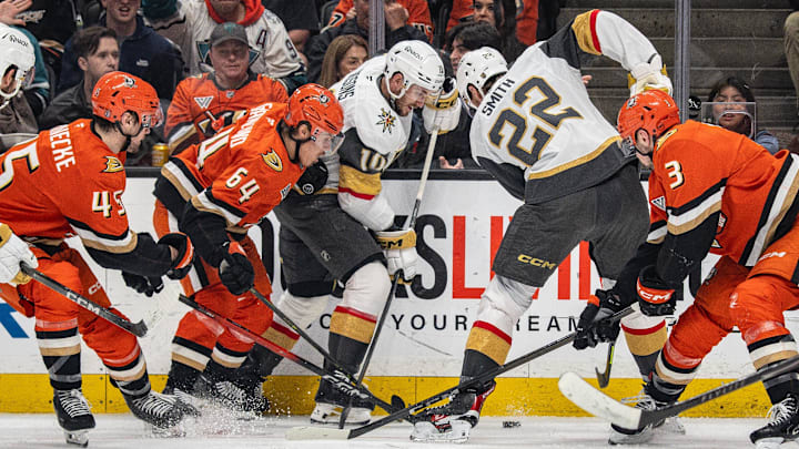 Colton Sissons, Cole Smith, and multiple Ducks battling for the puck