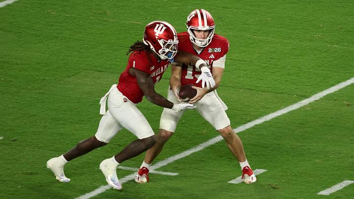 Jan 19, 2026; Miami Gardens, FL, USA; Indiana Hoosiers quarterback Fernando Mendoza (15) hands the ball to running back Roman Hemby (1) against the Miami Hurricanes in the first quarter during the College Football Playoff National Championship game at Hard Rock Stadium. Mandatory Credit: Kim Klement Neitzel-Imagn Images