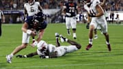 Sep 26, 2025; Charlottesville, Virginia, USA; Virginia Cavaliers quarterback Chandler Morris (4) scores a touchdown s Florida State Seminoles defensive back Ja'Bril Rawls (11) defends during the second quarter at Scott Stadium. Mandatory Credit: Geoff Burke-Imagn Images