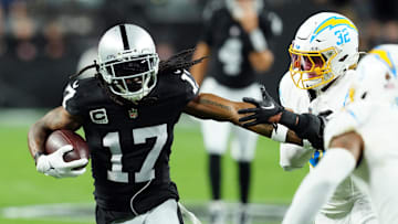 Dec 14, 2023; Paradise, Nevada, USA; Las Vegas Raiders wide receiver Davante Adams (17) runs against Los Angeles Chargers safety Alohi Gilman (32) in the first quarter at Allegiant Stadium. Mandatory Credit: Stephen R. Sylvanie-Imagn Images