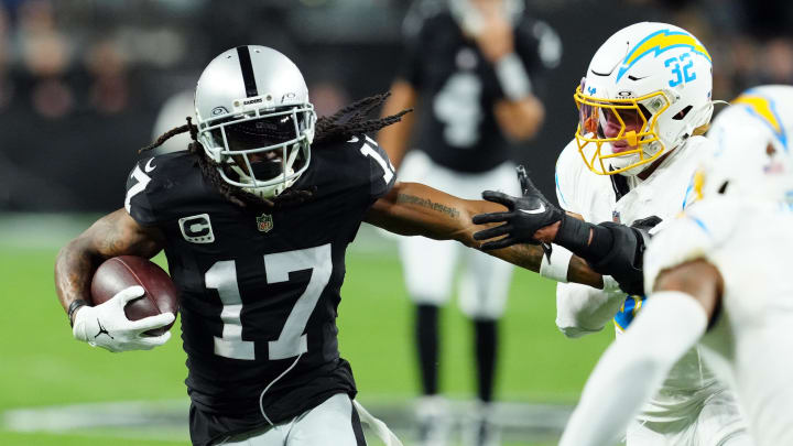 Dec 14, 2023; Paradise, Nevada, USA; Las Vegas Raiders wide receiver Davante Adams (17) runs against Los Angeles Chargers safety Alohi Gilman (32) in the first quarter at Allegiant Stadium. Mandatory Credit: Stephen R. Sylvanie-USA TODAY Sports