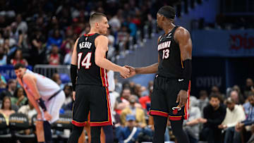 Mar 31, 2025; Washington, District of Columbia, USA; Miami Heat guard Tyler Herro (14) and center Bam Adebayo (13) react during the third quarter against the Washington Wizards at Capital One Arena. Mandatory Credit: Reggie Hildred-Imagn Images