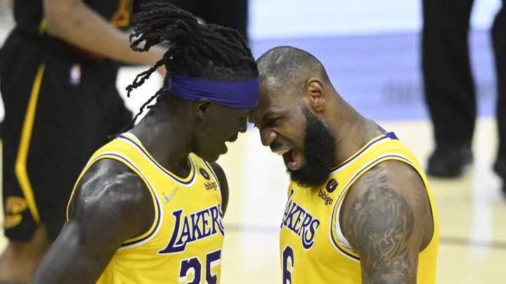 Mar 21, 2022; Cleveland, Ohio, USA; Los Angeles Lakers forward Wenyen Gabriel (35) and forward LeBron James (6) celebrate in the fourth quarter against the Cleveland Cavaliers at Rocket Mortgage FieldHouse. Mandatory Credit: David Richard-USA TODAY Sports