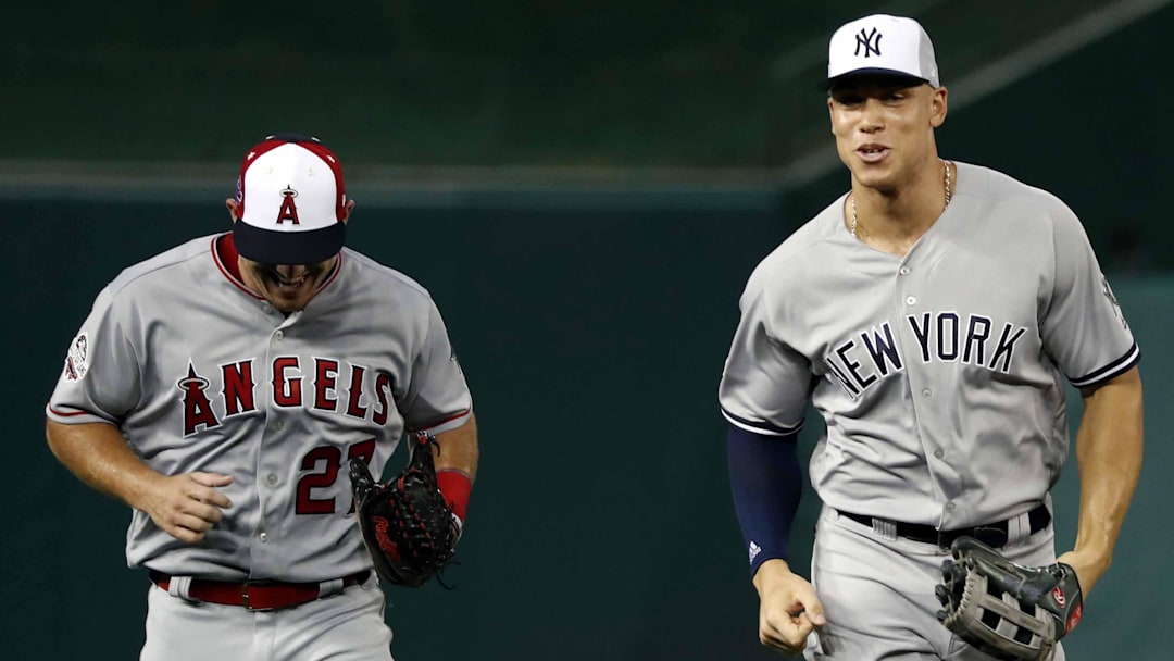 Jul 17, 2018; Washington, DC, USA; American League outfielder Aaron Judge of the New York Yankees (99) and American League outfielder Mike Trout of the Los Angeles Angels (27) run to the dug out after the first inning in the 2018 MLB All Star Game at Nationals Ballpark. 