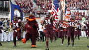 Virginia Tech Hokies players run onto the field 
