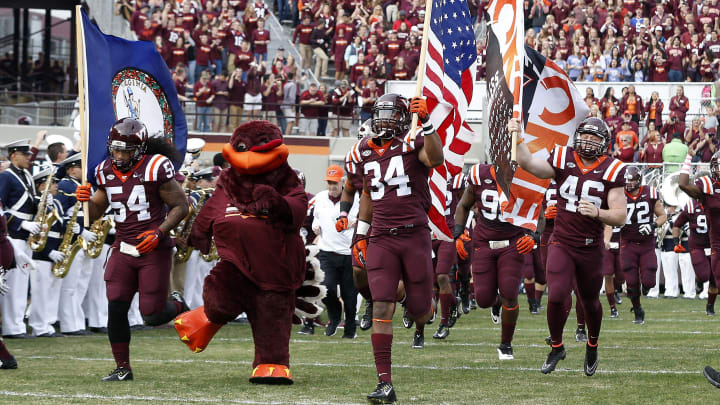 Virginia Tech Hokies players run onto the field 