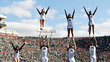 Notre Dame cheerleaders fly through the air in the first half of a NCAA football game against NC State at Notre Dame Stadium on Saturday, Oct. 11, 2025, in South Bend.