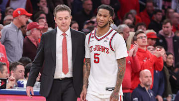 Feb 16, 2025; Queens, New York, USA;  St. John's Red Storm guard Deivon Smith (5) walks to the bench with head coach Rick Pitino in the second half against the Creighton Bluejays at Madison Square Garden. Mandatory Credit: Wendell Cruz-Imagn Images