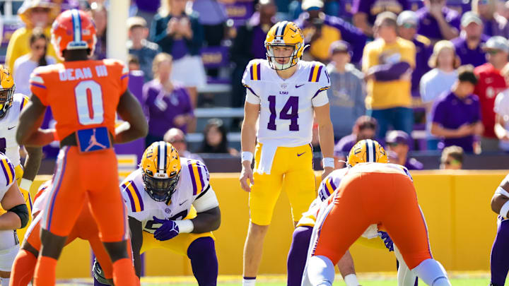 Oct 16, 2021; Baton Rouge, Louisiana, USA;  LSU Tigers quarterback Max Johnson (14) looks over the Florida Gators defense during the first half  at Tiger Stadium. Mandatory Credit: Stephen Lew-Imagn Images