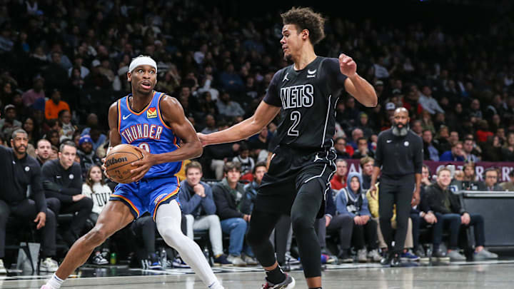 Jan 5, 2024; Brooklyn, New York, USA;  Oklahoma City Thunder guard Shai Gilgeous-Alexander (2) dribbles against Brooklyn Nets forward Cameron Johnson (2) in the third quarter at Barclays Center. Mandatory Credit: Wendell Cruz-Imagn Images