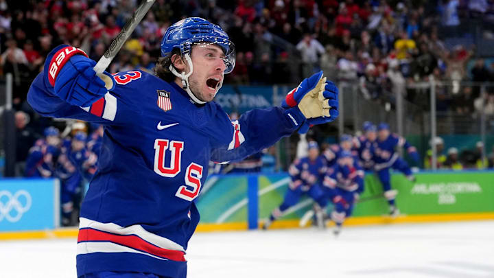 Feb 18, 2026; Milan, Italy; Quinn Hughes (43) of the United States celebrates his winning goal in overtime against Sweden in a men's ice hockey quarterfinal during the Milano Cortina 2026 Olympic Winter Games at Milano Santagiulia Ice Hockey Arena. Mandatory Credit: Amber Searls-Imagn Images