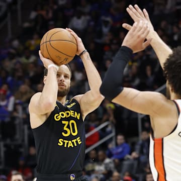 Jan 9, 2025; Detroit, Michigan, USA;  Golden State Warriors guard Stephen Curry (30) shoots against Detroit Pistons guard Cade Cunningham (2) in the second half at Little Caesars Arena. Mandatory Credit: Rick Osentoski-Imagn Images