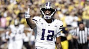 Washington Huskies wide receiver Denzel Boston celebrates after he makes a reception against the Michigan Wolverines