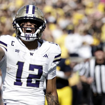 Washington Huskies wide receiver Denzel Boston celebrates after he makes a reception against the Michigan Wolverines