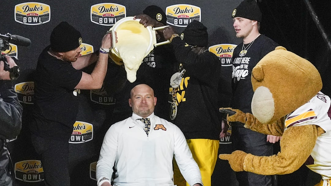 Jan 3, 2025; Charlotte, NC, USA;  Minnesota Golden Gophers head coach P.J. Fleck prepares for the mayo dump after his teams’ win over Virginia Tech Hokies  at the Duke’s Mayo Bowl at Bank of America Stadium. Mandatory Credit: Jim Dedmon-Imagn Images