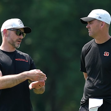 Jun 10, 2025; Cincinnati, OH, USA; Cincinnati Bengals offensive coordinator Dan Pitcher and head coach Zac Taylor talk during practice at Paycor Stadium. Mandatory Credit: Kareem Elgazzar-Imagn Images