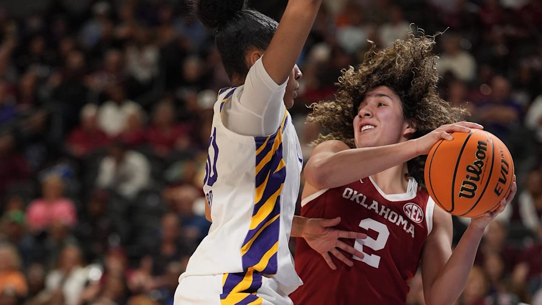 Oklahoma Sooners guard Aaliyah Chavez (2) pressured under the basket by Louisiana State Tigers guard Jada Richard (30) during the first half at Bon Secours Wellness Arena on Friday.