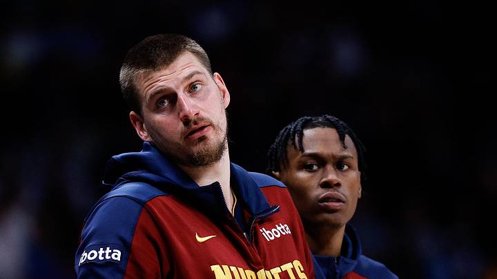 Apr 1, 2025; Denver, Colorado, USA; Denver Nuggets center Nikola Jokic (15) and forward Peyton Watson (8) look on from the sideline in the second quarter against the Minnesota Timberwolves at Ball Arena. Mandatory Credit: Isaiah J. Downing-Imagn Images