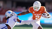 Texas Longhorns wide receiver Matthew Golden (2) stiff arms Kentucky Wildcats defensive back Maxwell Hairston (1) in the first quarter of an NCAA college football game at Darrell K Royal Texas Memorial Stadium in Austin, Texas on Saturday, Nov. 24, 2024.