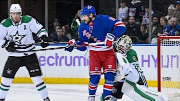 Jan 7, 2025; New York, New York, USA;  New York Rangers center Vincent Trocheck (16) deflects the puck past Dallas Stars goaltender Jake Oettinger (29) during the third period at Madison Square Garden. Mandatory Credit: Dennis Schneidler-Imagn Images
