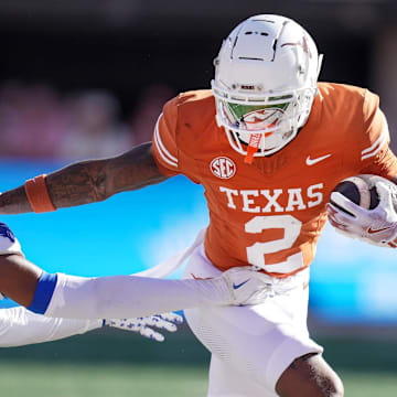 Texas Longhorns wide receiver Matthew Golden (2) stiff arms Kentucky Wildcats defensive back Maxwell Hairston (1) in the first quarter of an NCAA college football game at Darrell K Royal Texas Memorial Stadium in Austin, Texas on Saturday, Nov. 24, 2024.