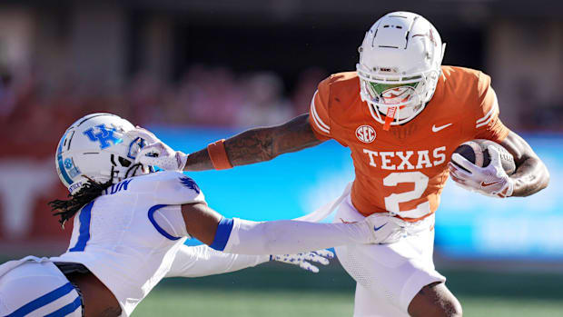 Texas Longhorns wide receiver Matthew Golden stiff arms Kentucky Wildcats defensive back Maxwell Hairston. 