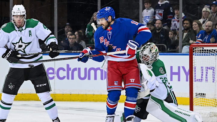 Jan 7, 2025; New York, New York, USA;  New York Rangers center Vincent Trocheck (16) deflects the puck past Dallas Stars goaltender Jake Oettinger (29) during the third period at Madison Square Garden. Mandatory Credit: Dennis Schneidler-Imagn Images