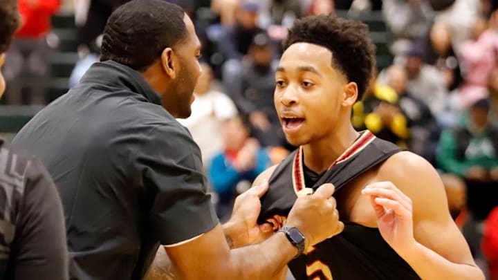 Penn Hills coach Chris Giles, left, celebrates with Amon Hawthorne, right, after he made three free throws to send the game to overtime Saturday at The Challenge at Allderdice. The Indians beat Neighborhood Academy, 58-57, in overtime.