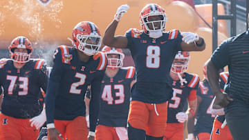 Dec 31, 2024; Orlando, FL, USA; Illinois Fighting Illini wide receiver Malik Elzy (8) and Illinois Fighting Illini wide receiver Ashton Hollins (2) lead the team out of the tunnel before the game against the South Carolina Gamecocks at Camping World Stadium. Mandatory Credit: Jeremy Reper-Imagn Images