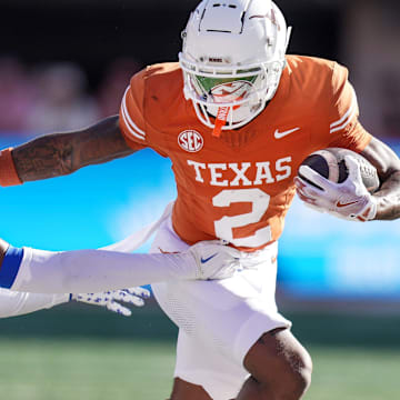 Texas Longhorns wide receiver Matthew Golden stiff arms Kentucky Wildcats defensive back Maxwell Hairston.