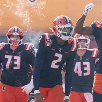 Dec 31, 2024; Orlando, FL, USA; Illinois Fighting Illini wide receiver Malik Elzy (8) and Illinois Fighting Illini wide receiver Ashton Hollins (2) lead the team out of the tunnel before the game against the South Carolina Gamecocks at Camping World Stadium. Mandatory Credit: Jeremy Reper-Imagn Images