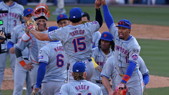 Oct 14, 2024; Los Angeles, California, USA; New York Mets shortstop Francisco Lindor (12) reacts with outfielder Tyrone Taylor (15) after game two of the NLCS for the 2024 MLB Playoffs at Dodger Stadium. Mandatory Credit: Jason Parkhurst-Imagn Images