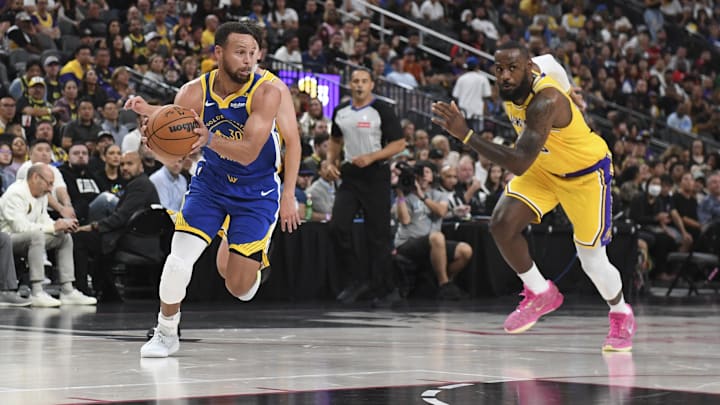 Oct 15, 2024; Las Vegas, Nevada, USA; Golden State Warriors guard Stephen Curry (30) drives past Los Angeles Lakers forward LeBron James (23) in the second quarter during a preseason game at T-Mobile Arena. Mandatory Credit: Candice Ward-Imagn Images