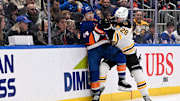 Nov 27, 2024; Elmont, New York, USA;  Boston Bruins defenseman Parker Wotherspoon (29) checks New York Islanders center Jean-Gabriel Pageau (44) into the boards during the second period at UBS Arena. Mandatory Credit: Dennis Schneidler-Imagn Images