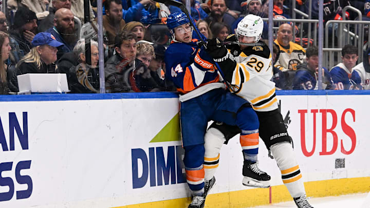 Nov 27, 2024; Elmont, New York, USA; Boston Bruins defenseman Parker Wotherspoon (29) checks New York Islanders center Jean-Gabriel Pageau (44) into the boards during the second period at UBS Arena. Mandatory Credit: Dennis Schneidler-Imagn Images Nov 27, 2024; Elmont, New York, USA; Boston Bruins defenseman Parker Wotherspoon (29) checks New York Islanders center Jean-Gabriel Pageau (44) into the boards during the second period at UBS Arena. Mandatory Credit: Dennis Schneidler-Imagn Images
