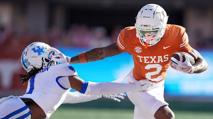 Texas Longhorns wide receiver Matthew Golden stiff arms Kentucky Wildcats defensive back Maxwell Hairston. Texas Longhorns wide receiver Matthew Golden stiff arms Kentucky Wildcats defensive back Maxwell Hairston.