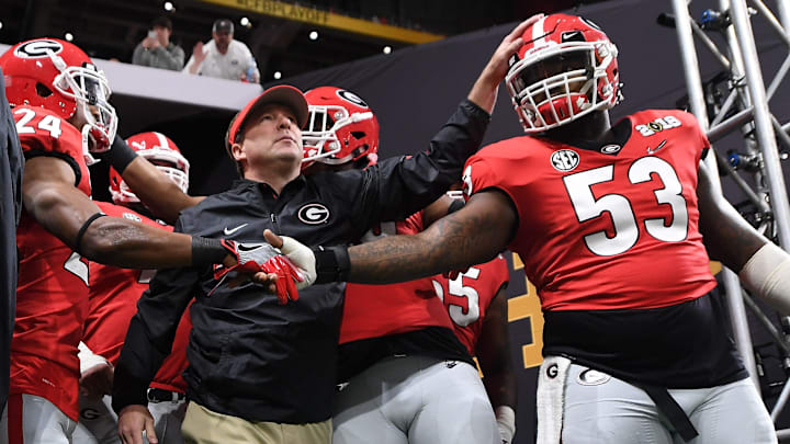 Georgia running back Prather Hudson (24), Georgia head coach Kirby Smart and Georgia center Lamont Gaillard (53) take the field before the College Football Playoff National Championship game between Georgia and Alabama on Monday, Jan. 8, 2017 in Atlanta, Ga. (AJ Reynolds for the Athens Banner-Herald) Georgia running back Prather Hudson (24), Georgia head coach Kirby Smart and Georgia center Lamont Gaillard (53) take the field before the College Football Playoff National Championship game between Georgia and Alabama on Monday, Jan. 8, 2017 in Atlanta, Ga. (AJ Reynolds for the Athens Banner-Herald)