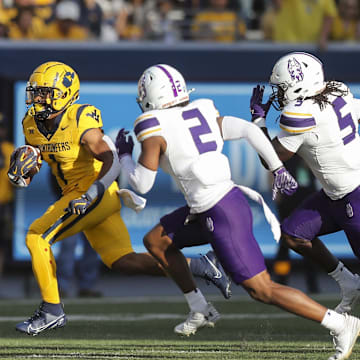 Sep 7, 2024; Morgantown, West Virginia, USA; West Virginia Mountaineers running back Jahiem White (1) runs the ball during the first quarter against the Albany Great Danes at Mountaineer Field at Milan Puskar Stadium. Mandatory Credit: Ben Queen-Imagn Images