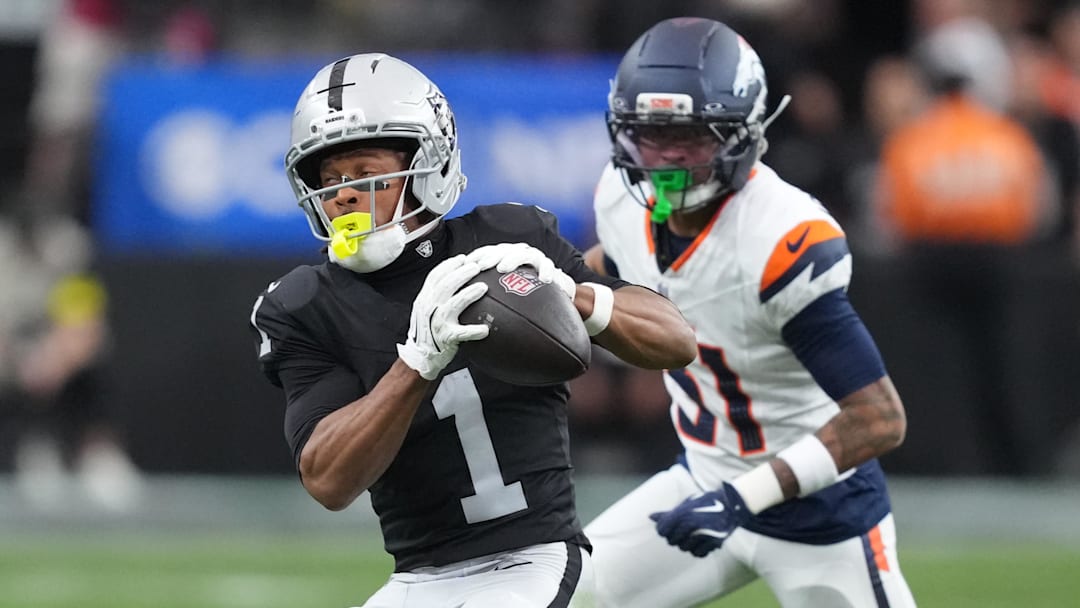 Dec 7, 2025; Paradise, Nevada, USA;  Las Vegas Raiders wide receiver Tre Tucker (1) makes the catch as Denver Broncos cornerback Kris Abrams-Draine (31) defends.