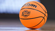 A March Madness basketball sits on the court during a timeout during the midwest regional semifinals