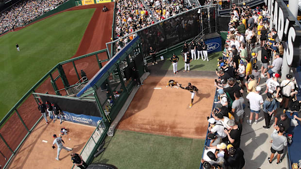Apr 19, 2025; Pittsburgh, Pennsylvania, USA;  Fans look on as Pittsburgh Pirates starting pitcher Paul Skenes warms up.
