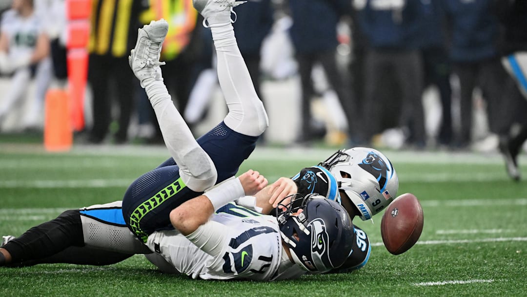 Dec 28, 2025; Charlotte, North Carolina, USA; Carolina Panthers linebacker D.J. Wonnum (98) sacks Seattle Seahawks quarterback Sam Darnold (14) during the fourth quarter at Bank of America Stadium. 