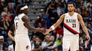 Nov 12, 2025; New Orleans, Louisiana, USA: Portland Trail Blazers guard Jrue Holiday (5) slaps hands with Portland forward Toumani Camara (33) after a play against the New Orleans Pelicans during the second half at Smoothie King Center. Mandatory Credit: Stephen Lew-Imagn Images